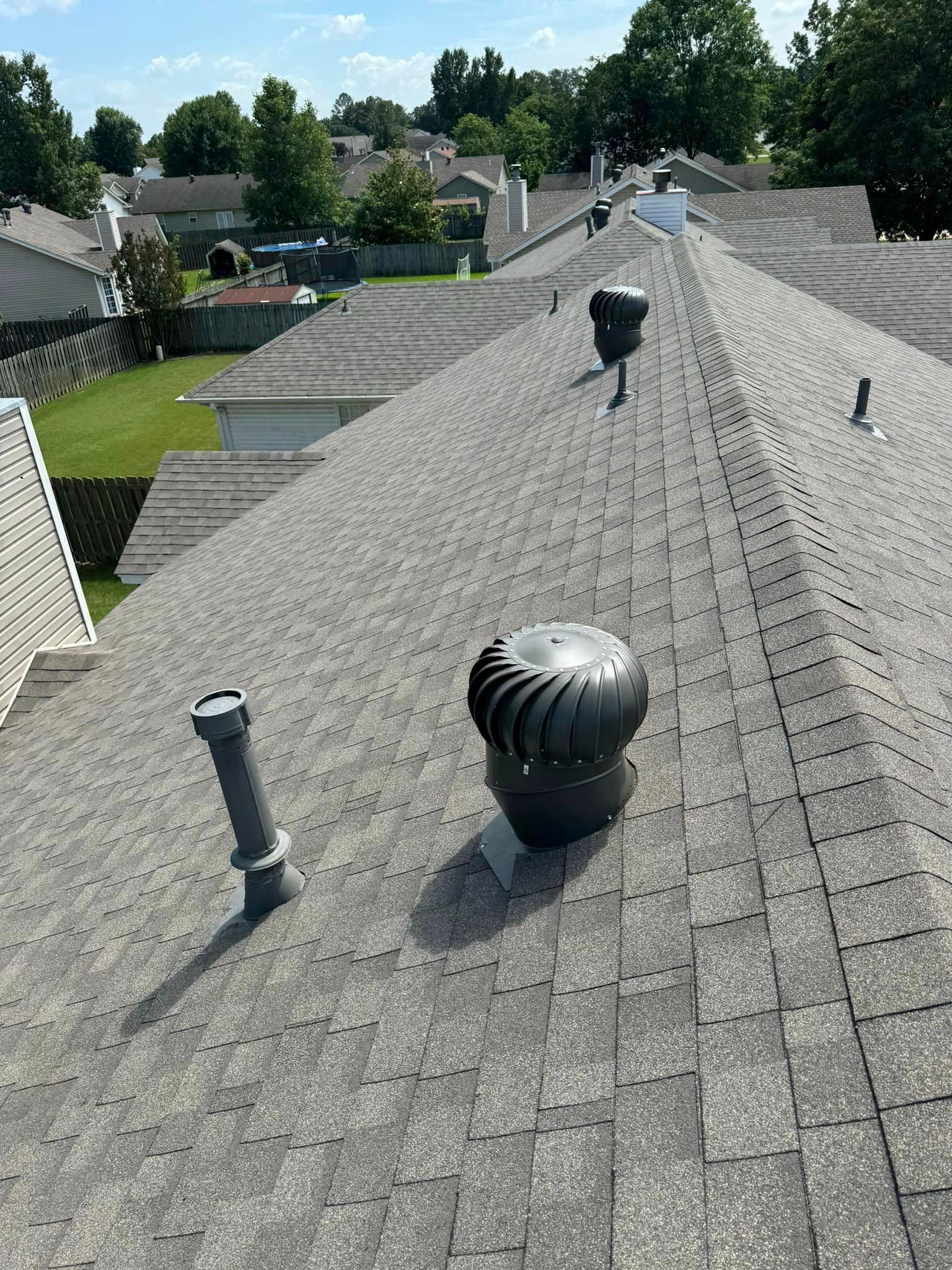 The roof of a house with a few vents on it.