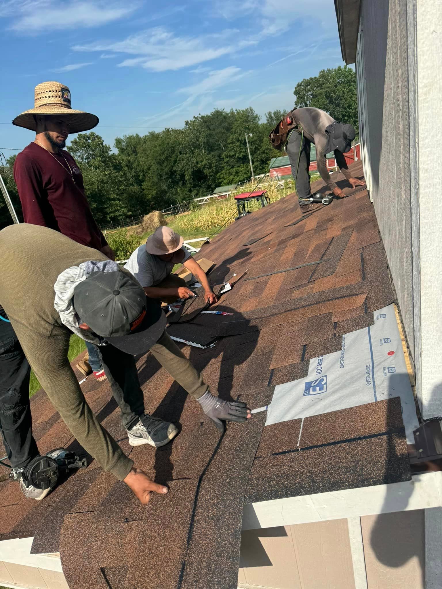 A group of people are working on a roof.