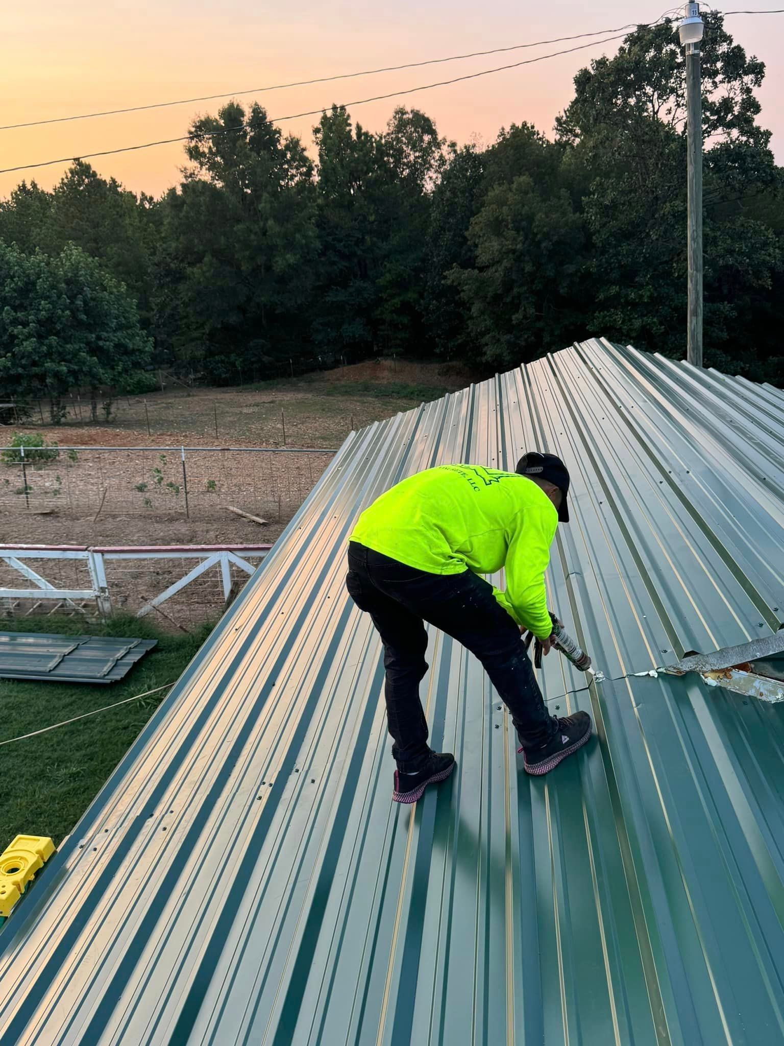 A man is working on the roof of a building.