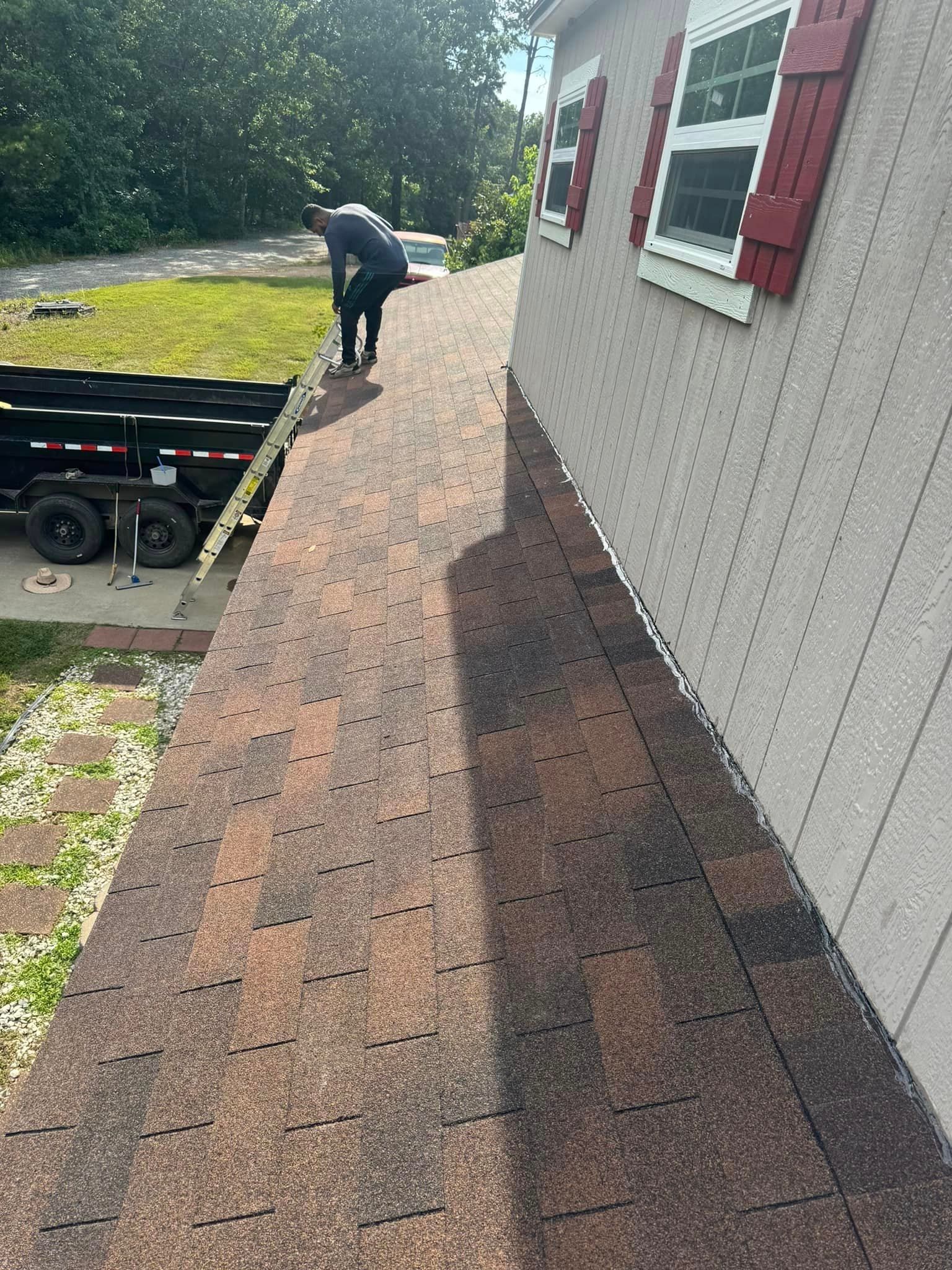 A man is working on the roof of a mobile home.