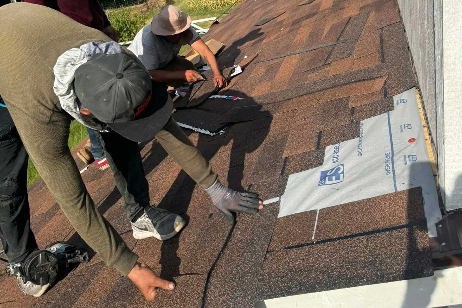 A group of men are working on a roof.
