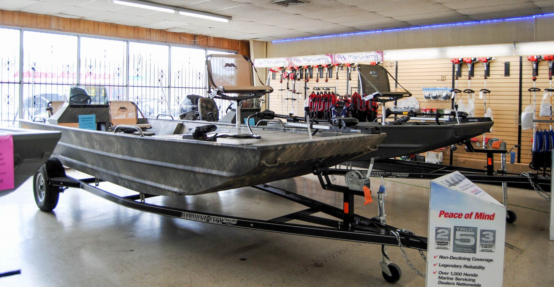 A boat is sitting on a trailer in a showroom