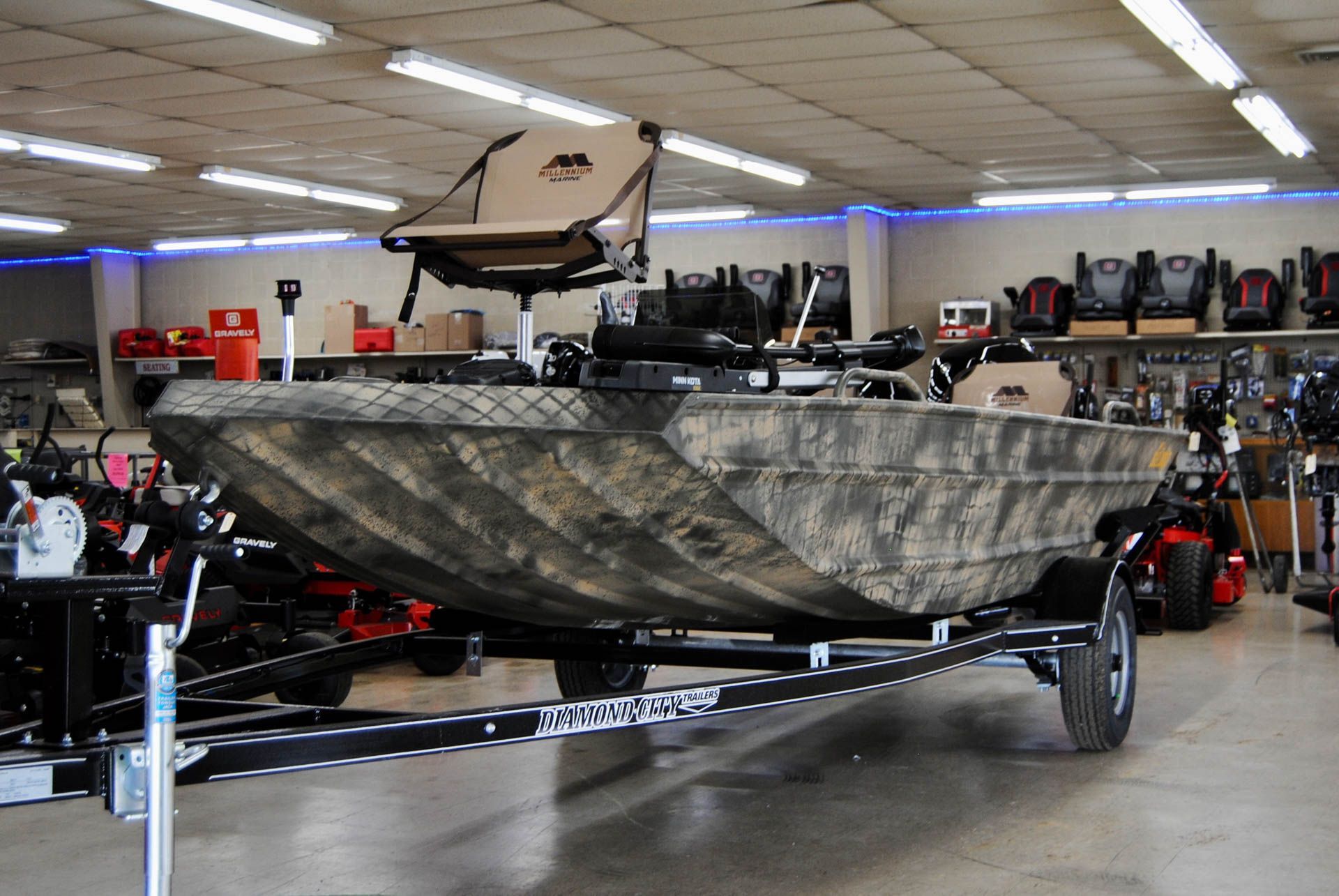 A boat is on a trailer in a showroom.