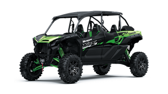 A green and black atv is sitting on top of a white surface.