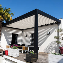 A patio with a pergola and a table and chairs