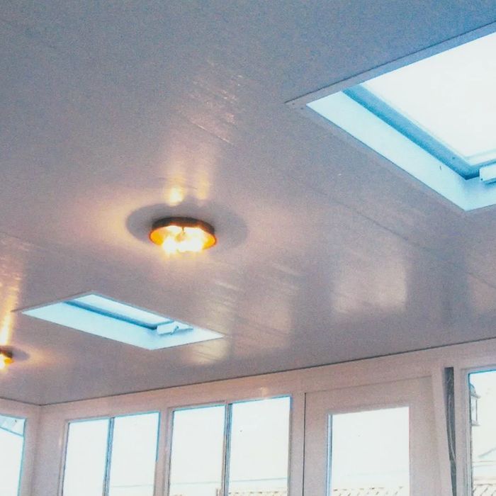 A room with a ceiling that has two skylights on it