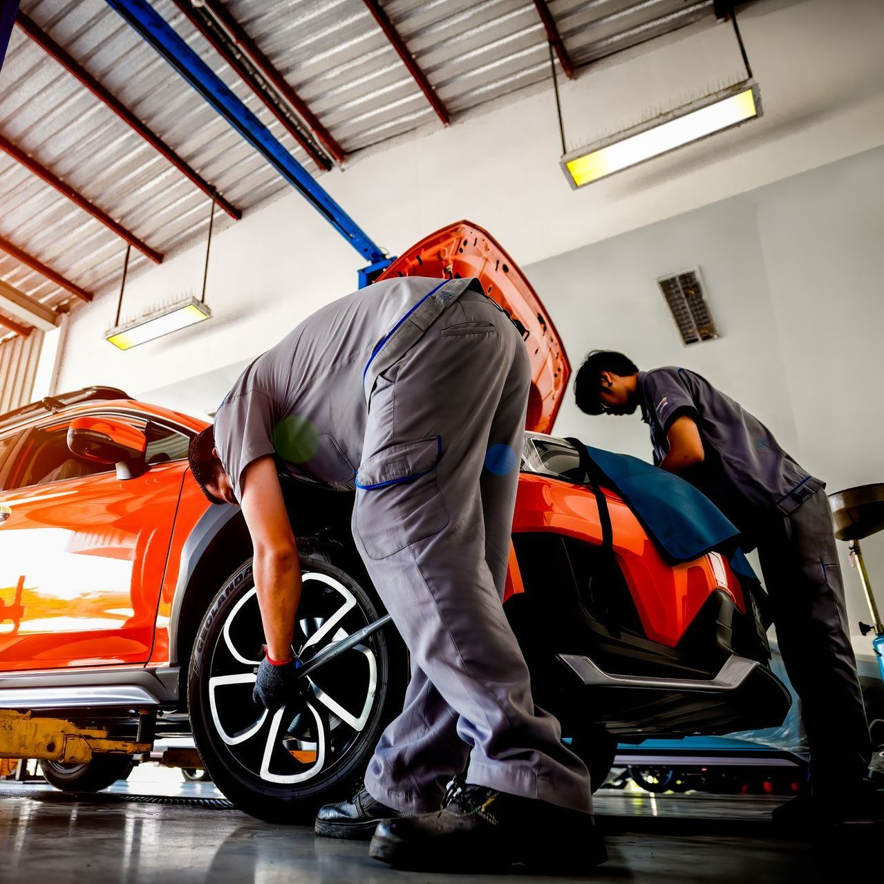 Two Mechanics Maintaining A Car - Des Moines, IA - Town & Country Service Center Two Mechanics Maintaining A Car - Des Moines, IA - Town & Country Service Center