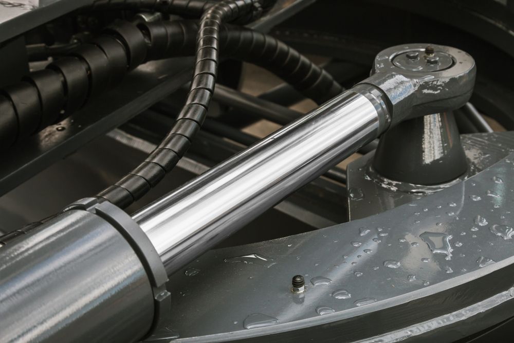 A Close Up Of A Hydraulic Cylinder With A Hose Attached To It — Gillies Enterprises Pty Ltd In Narrabri, NSW