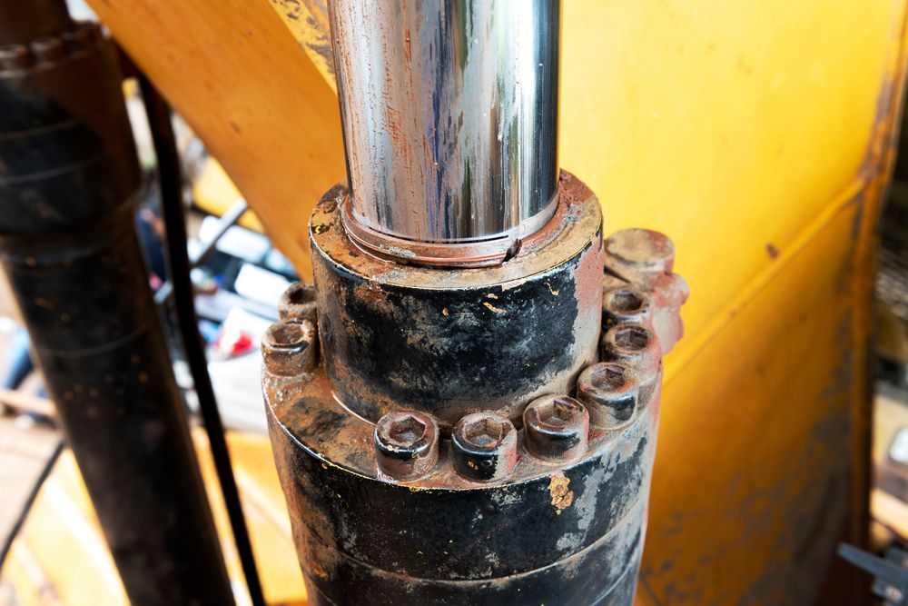 A Close Up Of A Hydraulic Cylinder On A Yellow Machine — Gillies Enterprises Pty Ltd In Narrabri, NSW