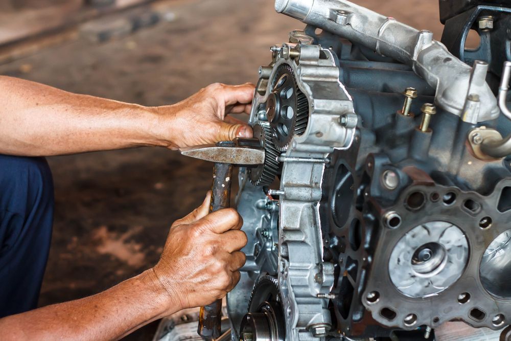 A Man Is Working On A Car Engine In A Garage — Gillies Enterprises Pty Ltd In Narrabri, NSW