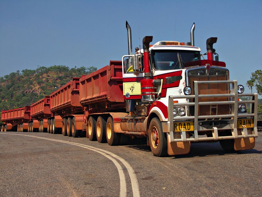 A Red and White Semi Truck With a License Plate That Says R040t — Gillies Enterprises Pty Ltd In Coonamble, NSW