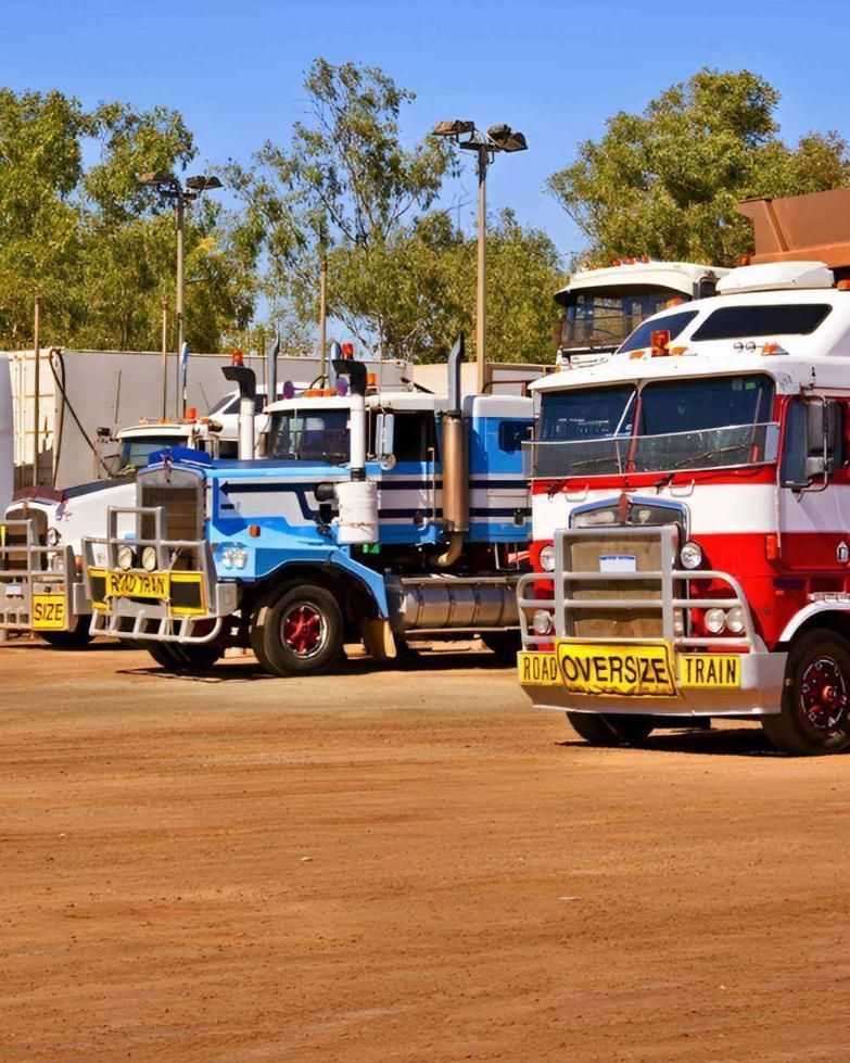 A Lineup of Trucks Parked on a Dirt Surface — Gillies Enterprises Pty Ltd In Coonamble, NSW