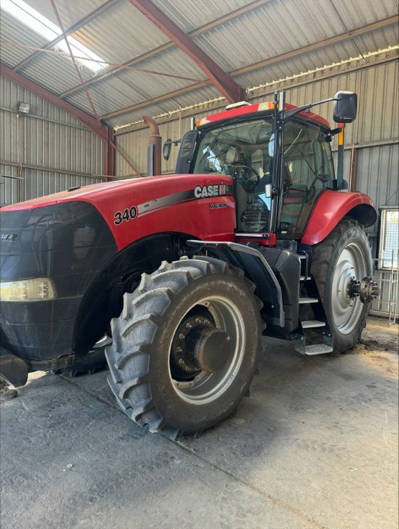 A Man In A Green Shirt Is Working On A Machine — Gillies Enterprises Pty Ltd In Narrabri, NSW