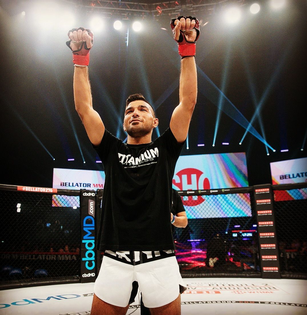 A man in a black shirt with the word titanium on it