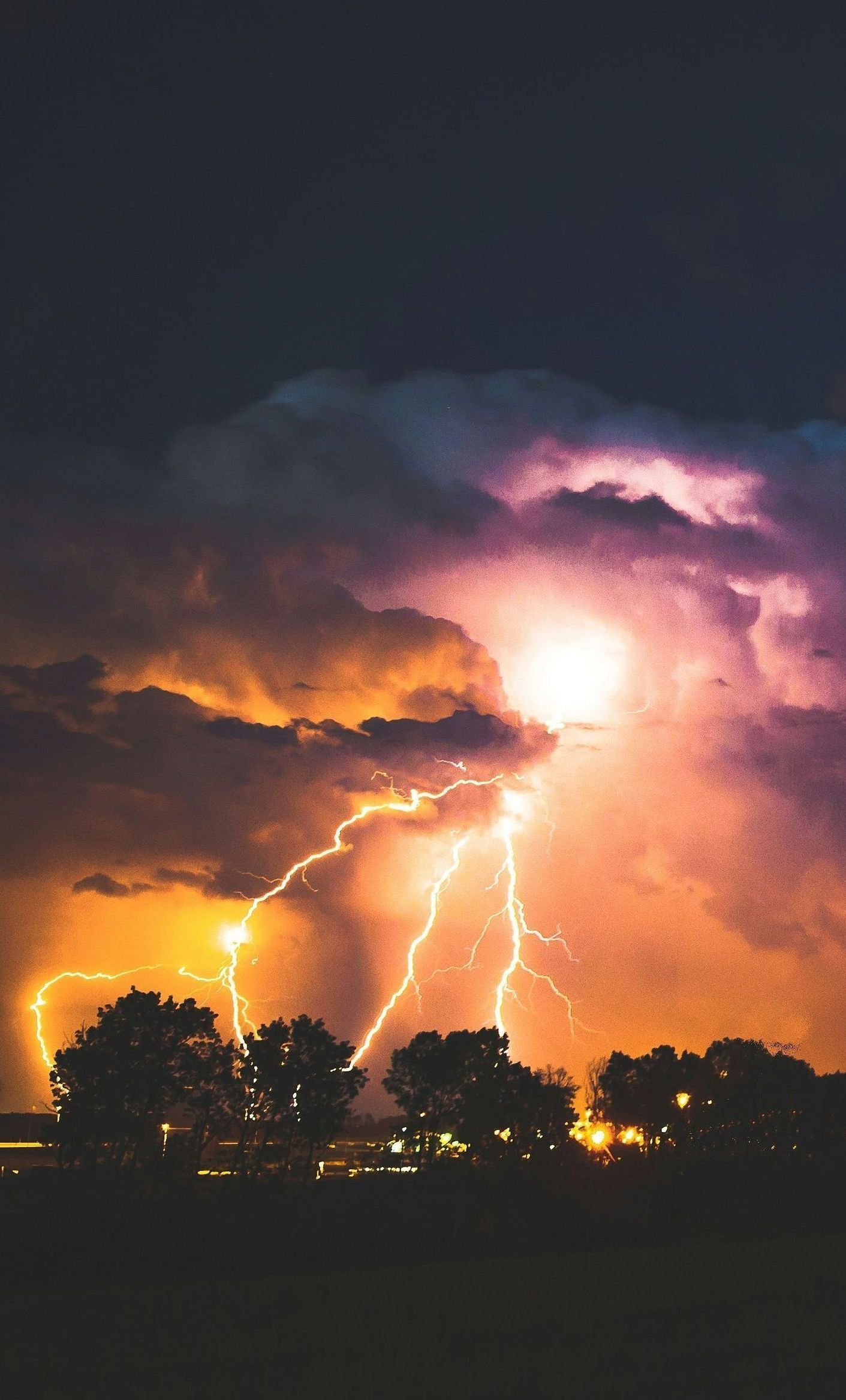 There is a lot of lightning in the sky at night.