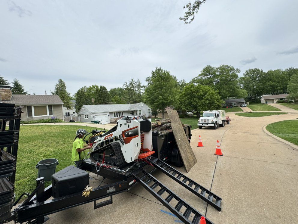 A man is standing next to a trailer with a machine on it.