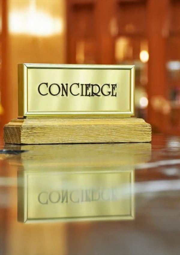 A specialist recruiter in a suit is smiling and holding a clipboard