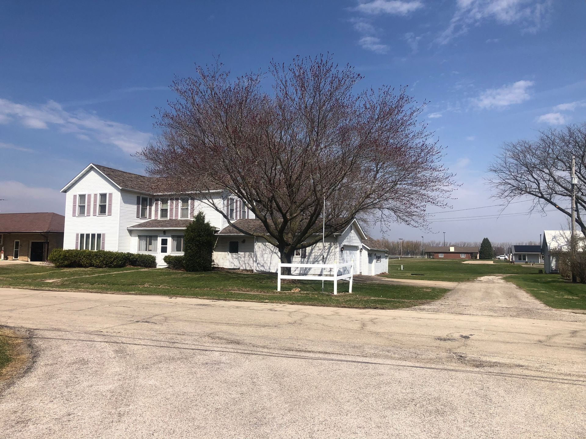 White farmhouse exterior with front yard — Sheffield, IL — Johnson Agency