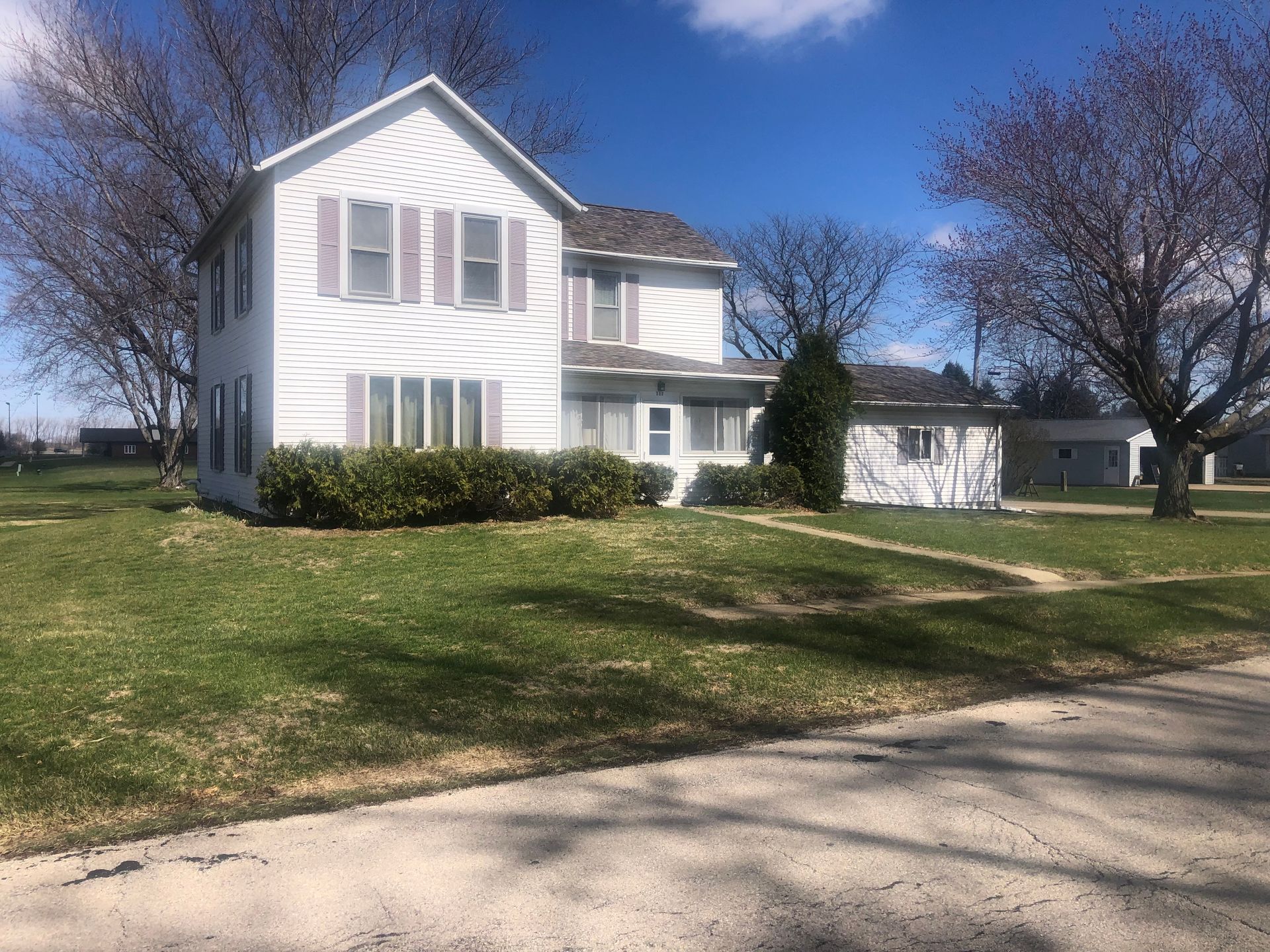 Two story white home with lawn and trees — Sheffield, IL — Johnson Agency