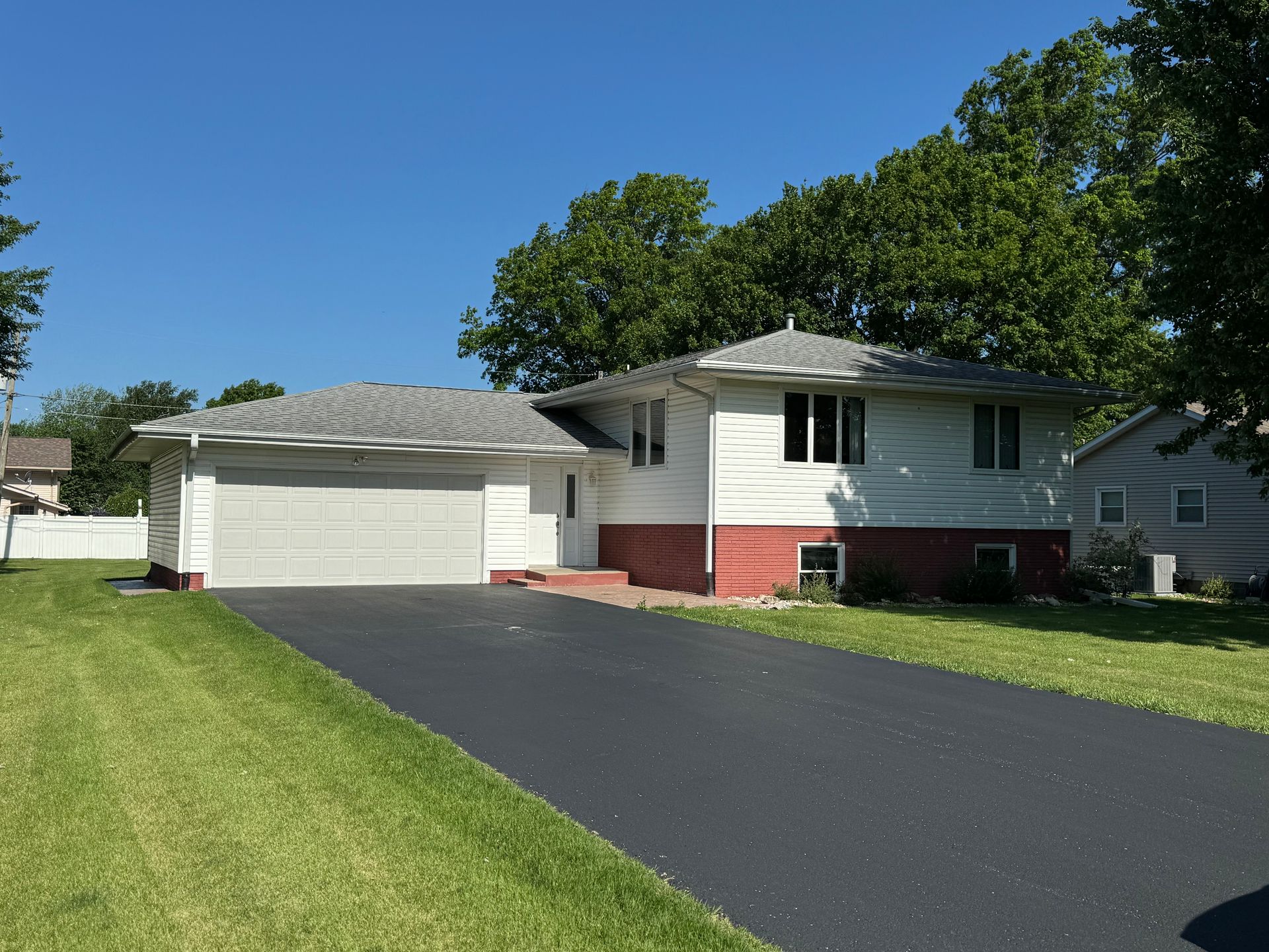 A house with a garage and a driveway in front of it