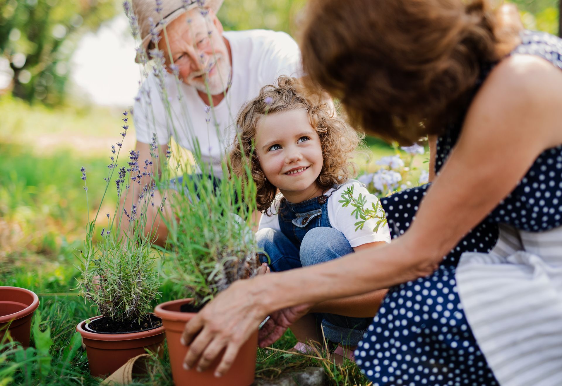 Grandparents gardening with young grandaughter teaching about the importance of smaller steps