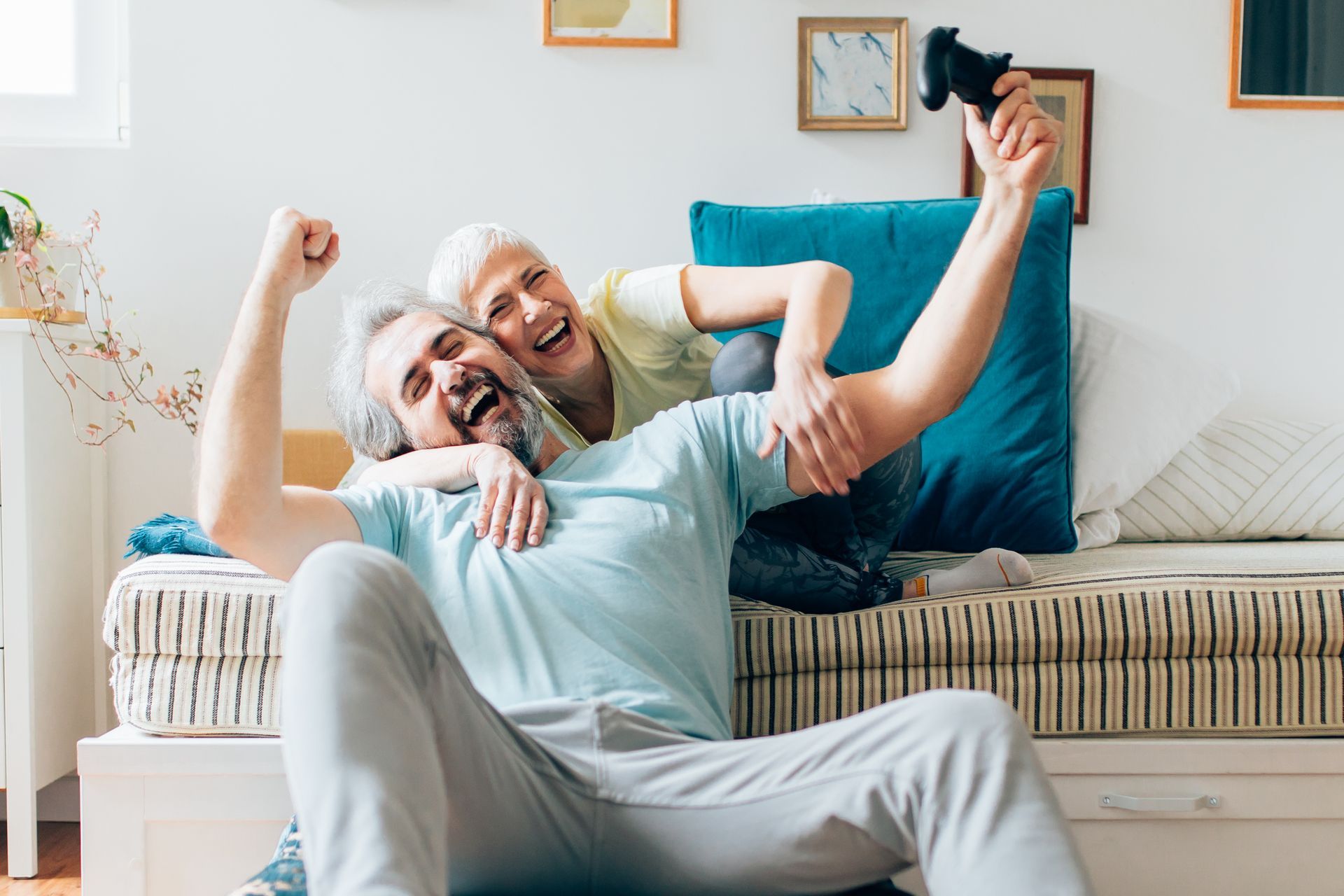 a man and a woman are playing a video game in a living room, practicing the 5 stepping stones in a relationship