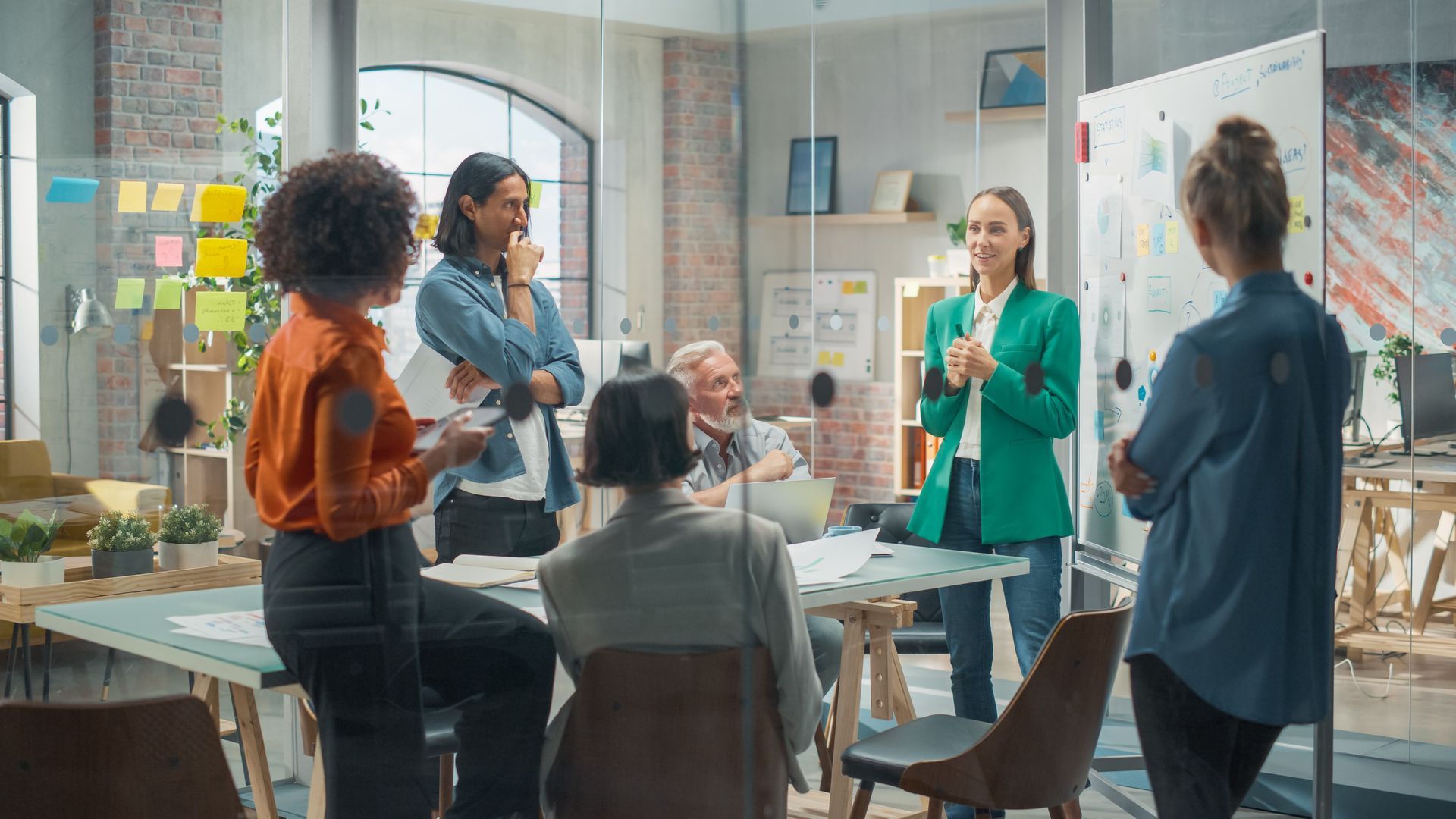 A young female executive gives a presentation after practicing strategies to achieve goals