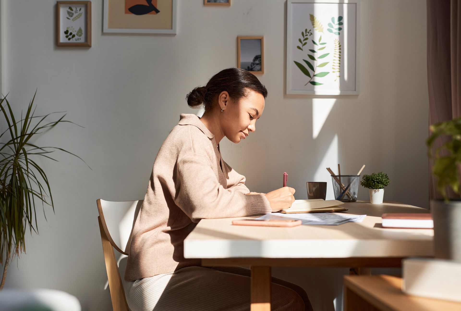 woman writing in a gratitude journal -- proving that mindset is everything