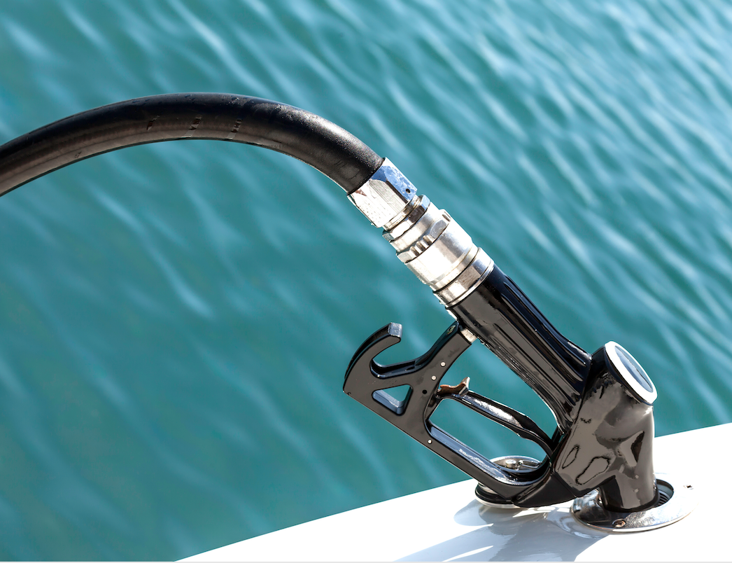 A gas pump is attached to the side of a boat