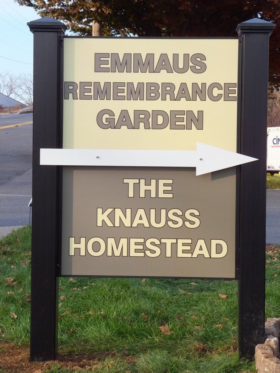 A sign with black posts pointing right, reading 