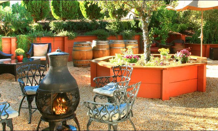 A patio area with a fire pit and chairs