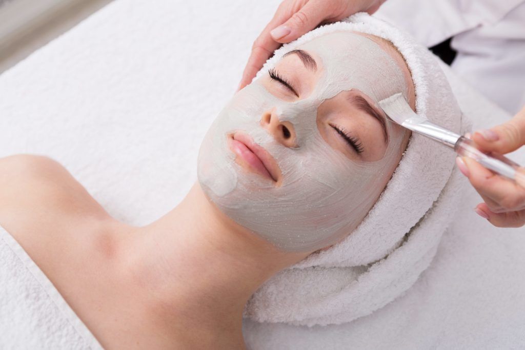 A woman is getting a facial treatment at a spa.