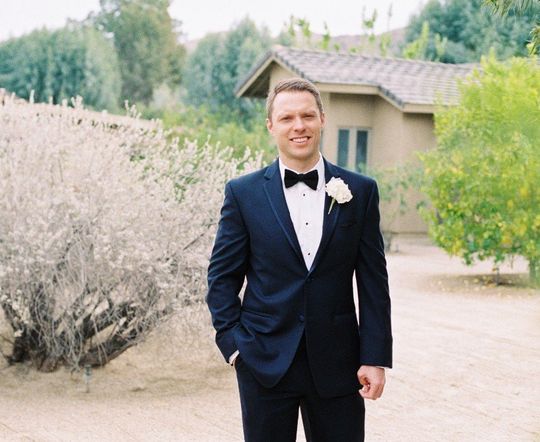 groom in tuxedo standing outside