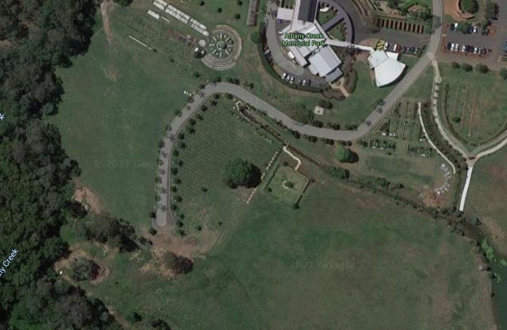 An aerial view of a park with a lot of grass and trees