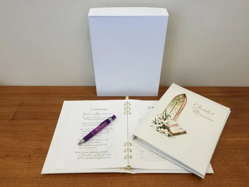 A book with a shoe on it is open to a page with a pen on it