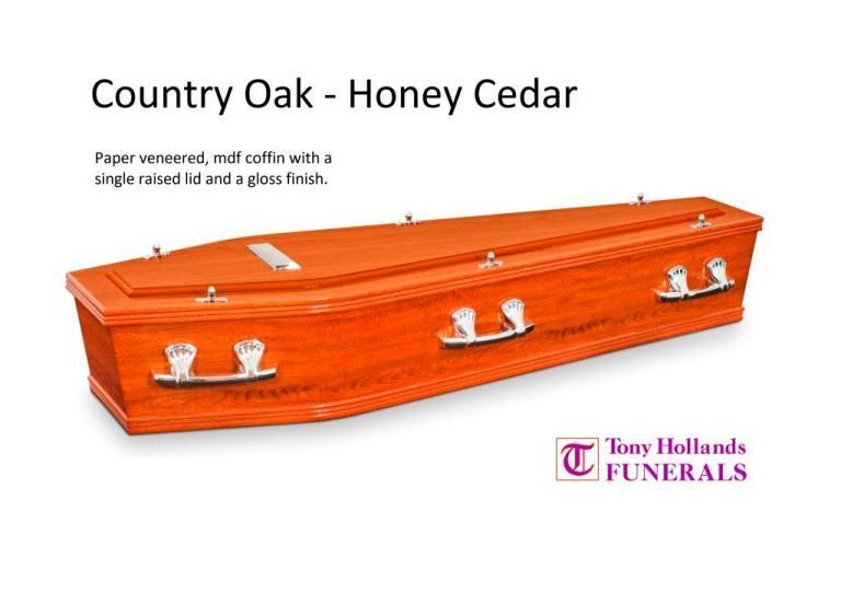 A picture of a country oak honey cedar coffin