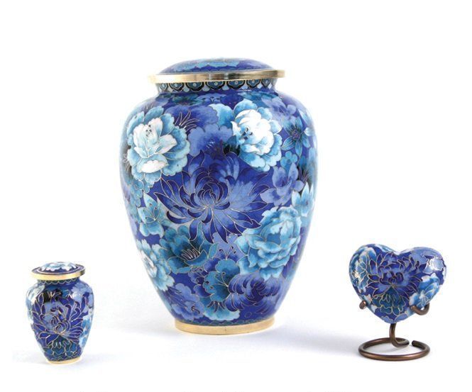 A blue vase with white flowers on it