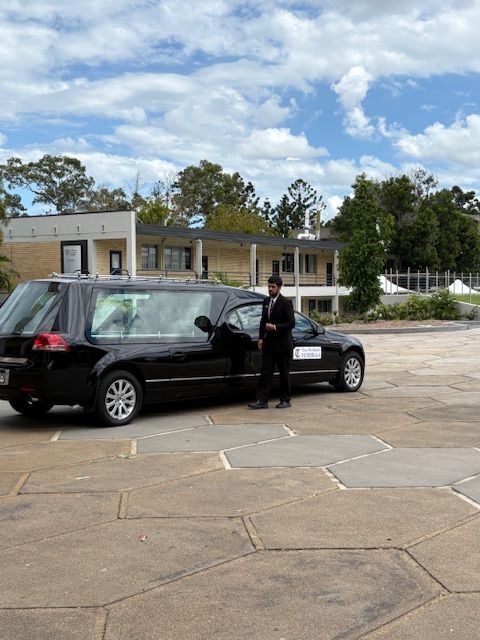 Image of a Statesman Hearse in the carpark of a church