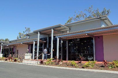 A large building with purple walls and a blue sky in the background.