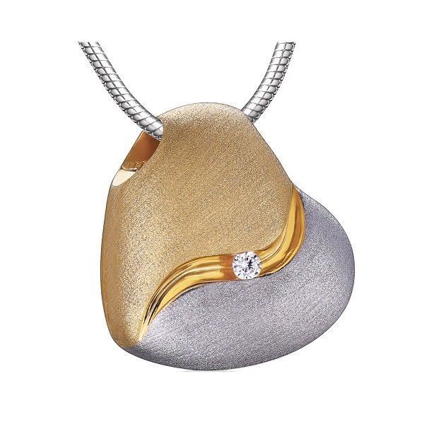 A gold and silver pendant with a diamond in the middle