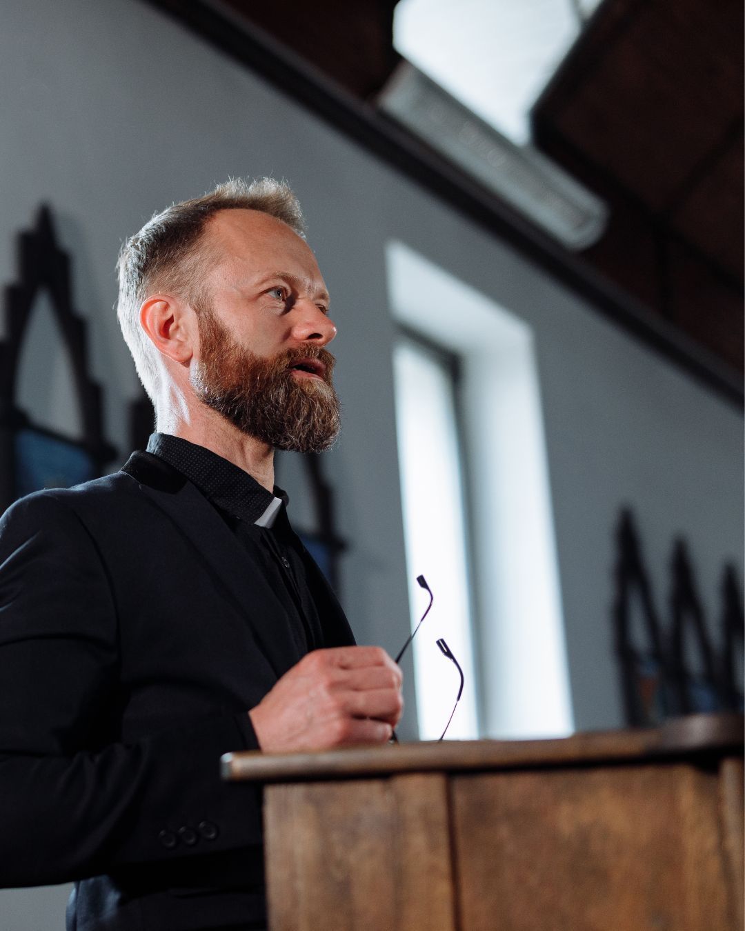 A woman is sitting at a table talking to another woman.