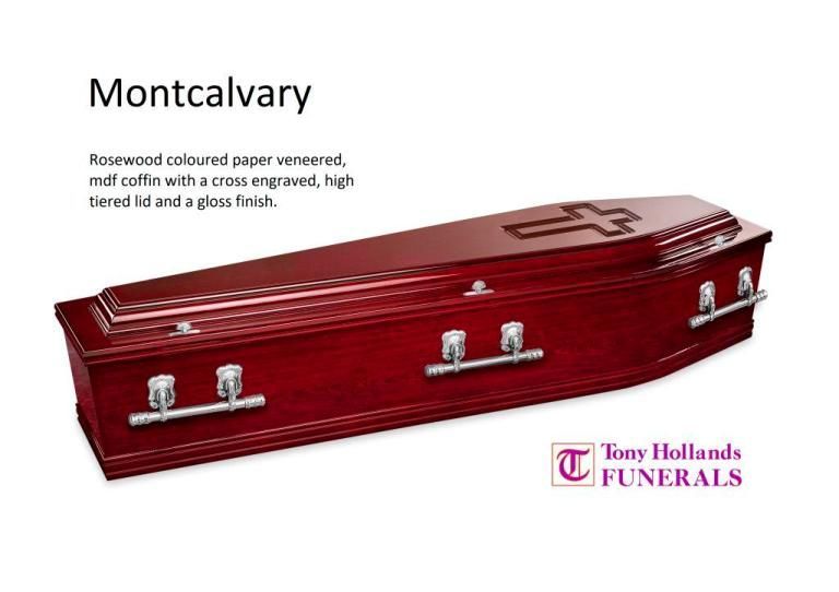 A wooden coffin with a cross engraved on it