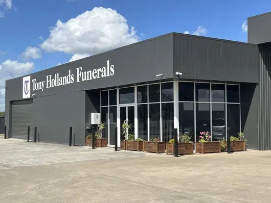 A tony hollands funerals building with a lot of windows