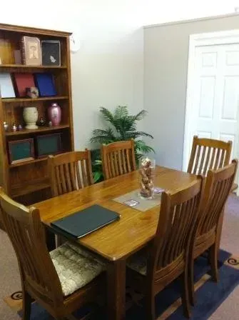 A dining room with a wooden table and chairs