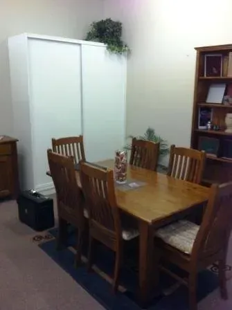 A dining room with a wooden table and chairs