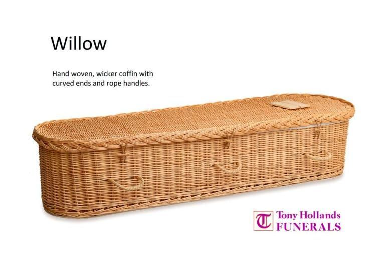 A wicker coffin with curved ends and rope handles.