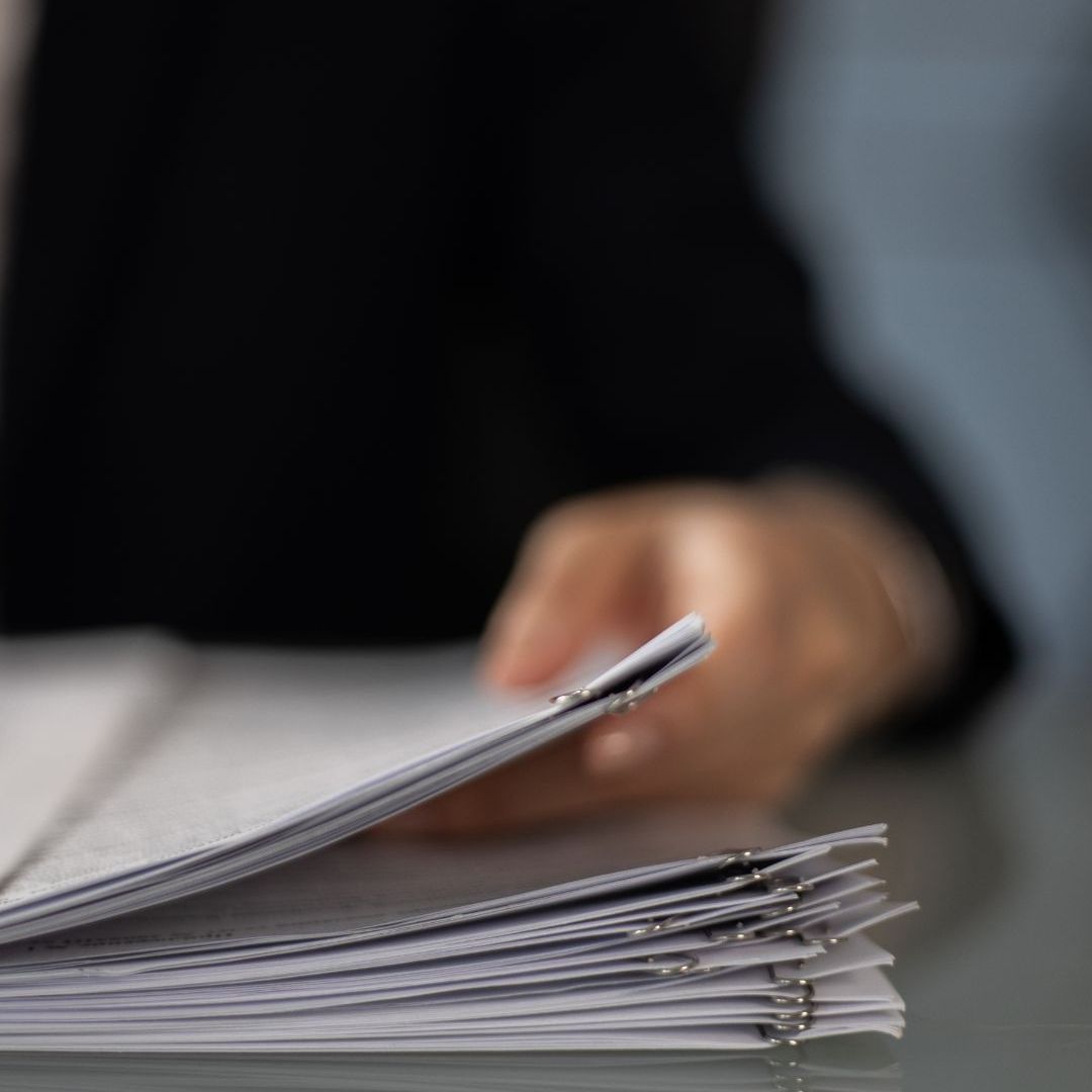A close up of a person holding a piece of paper
