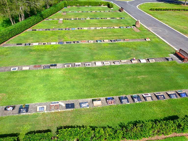 An aerial view of a cemetery with a lot of graves in it.