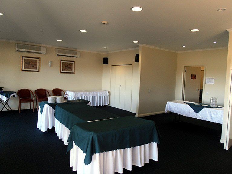 A room with a lot of tables and chairs