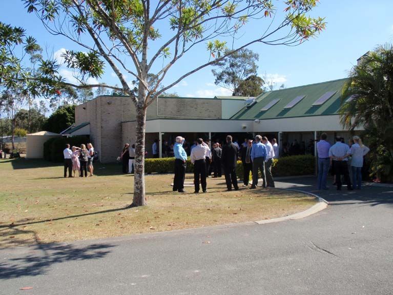 A group of people standing outside of a building